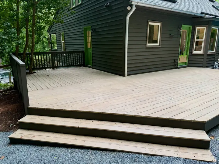 Back deck after a two-tone stain: dark rails and fascia, lighter boards