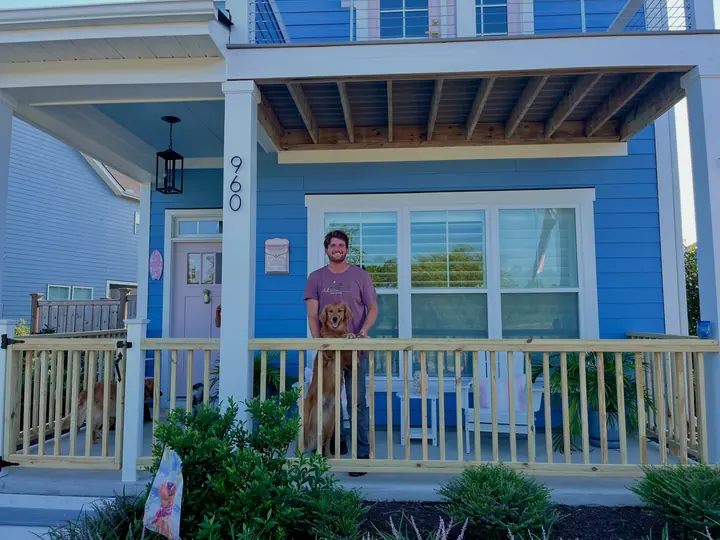 White picket porch fence on a blue house